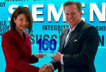 Jim Garrettson, CEO of Executive Mosaic, Presents Tina Dolph, President and CEO of Siemens Government Technologies, Her First Wash100 Award